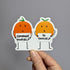 Two cartoon-style orange characters holding signs with motivational text against a gray background.
