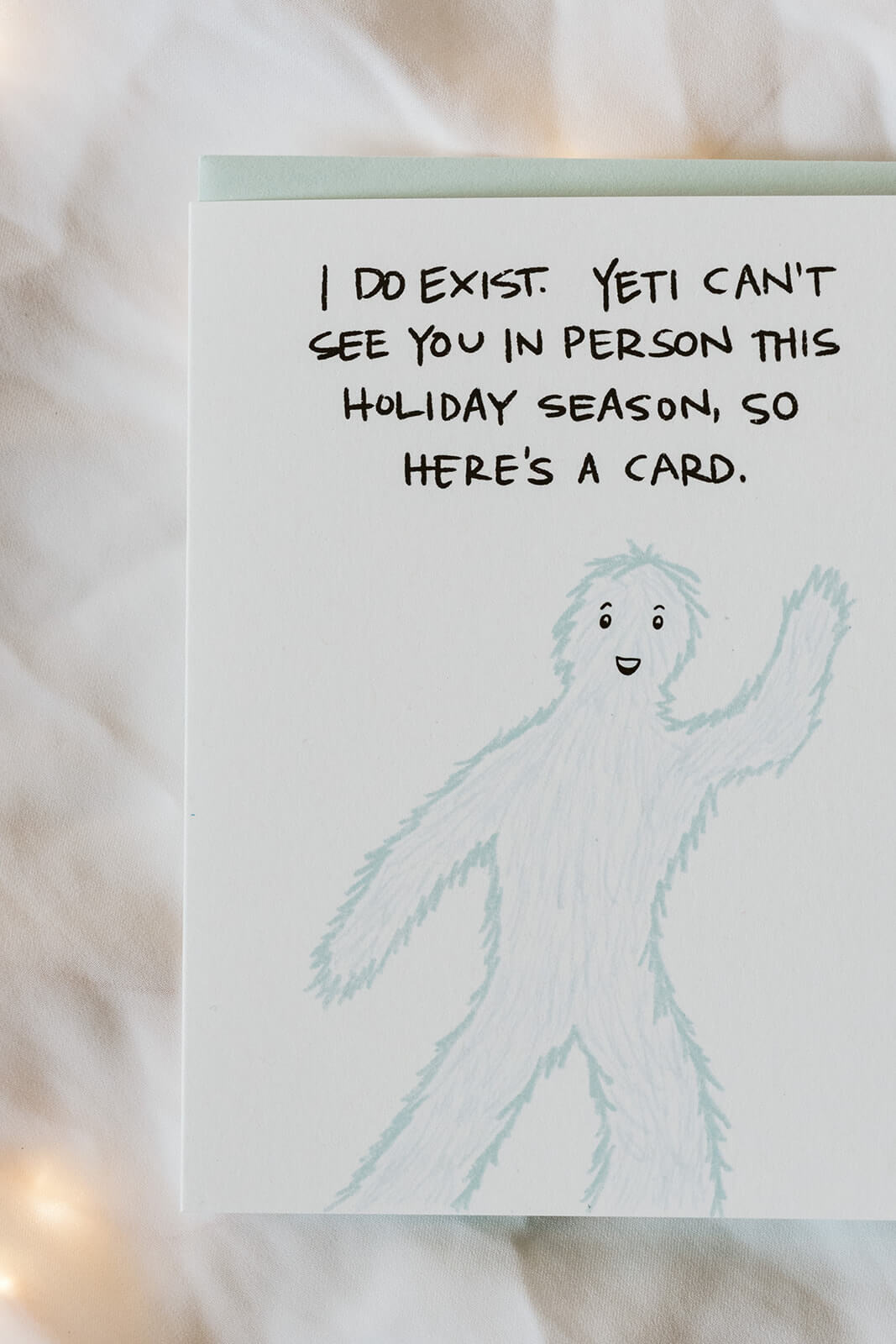witty Christmas card of a waving yet and the text "I do exist. Yeti can&