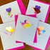 Valentine cards made with blush cardstock, a multi-colored triangle and holographic heart.