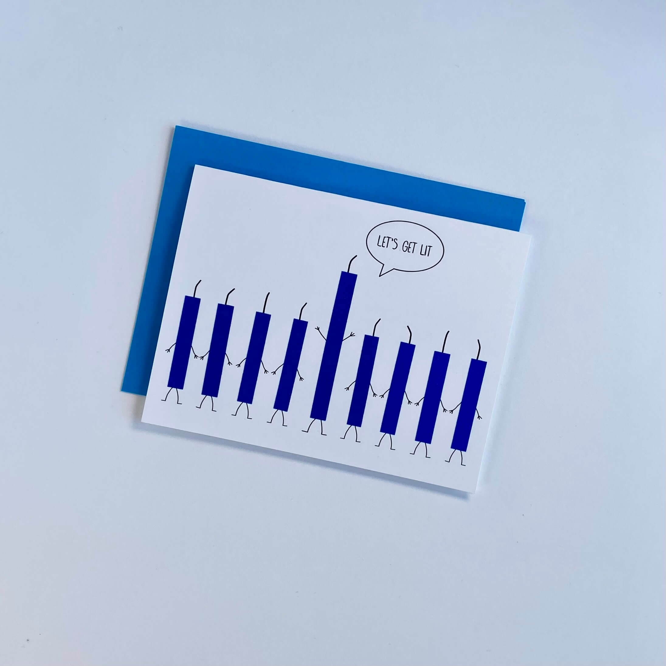 Hanukkah card with 9 blue glitter candles, one of which is saying, "Let&