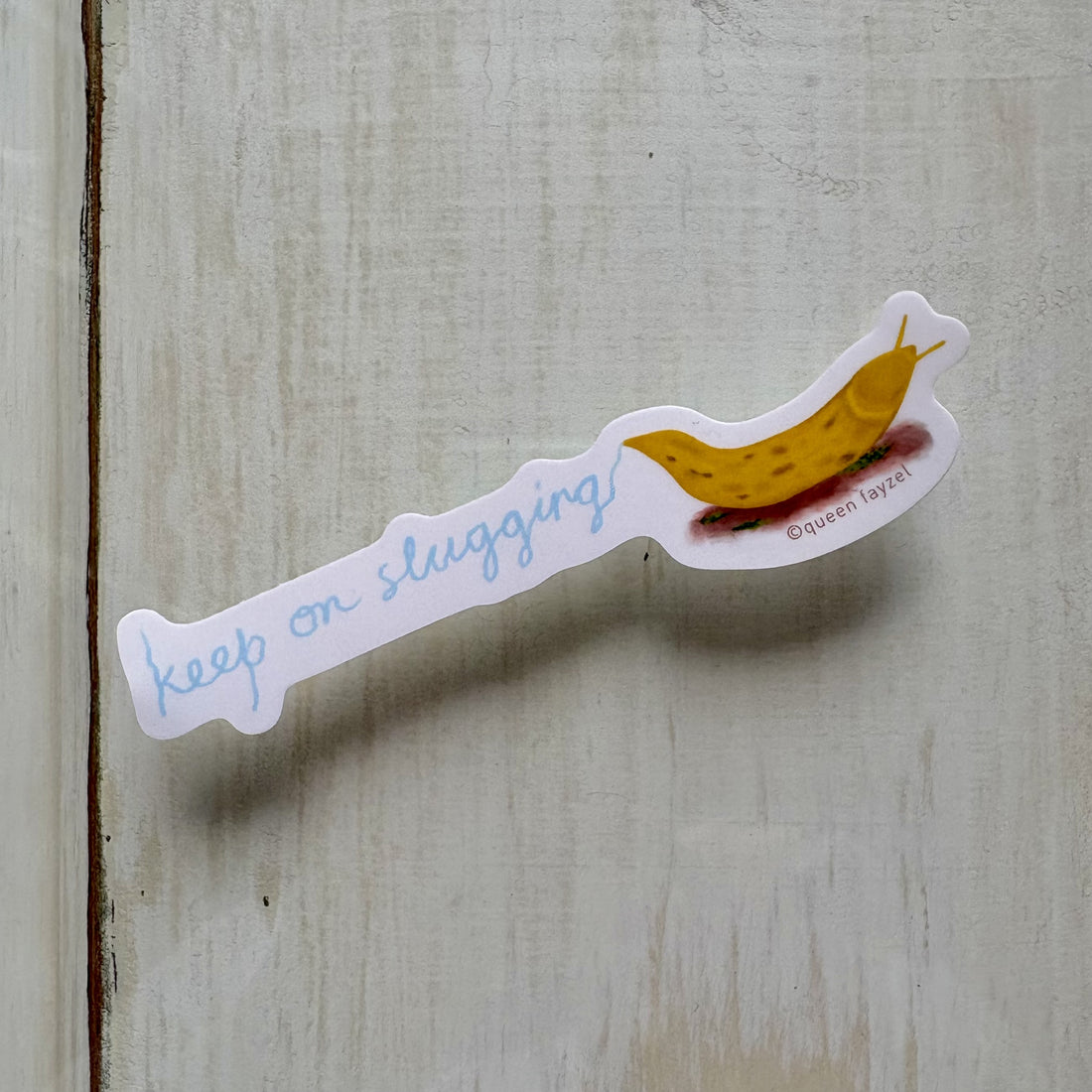 Sticker with a banana slug and &