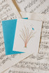 Friendship greeting card with a bluebird sitting in a plant, with little music notes to indicate singing.