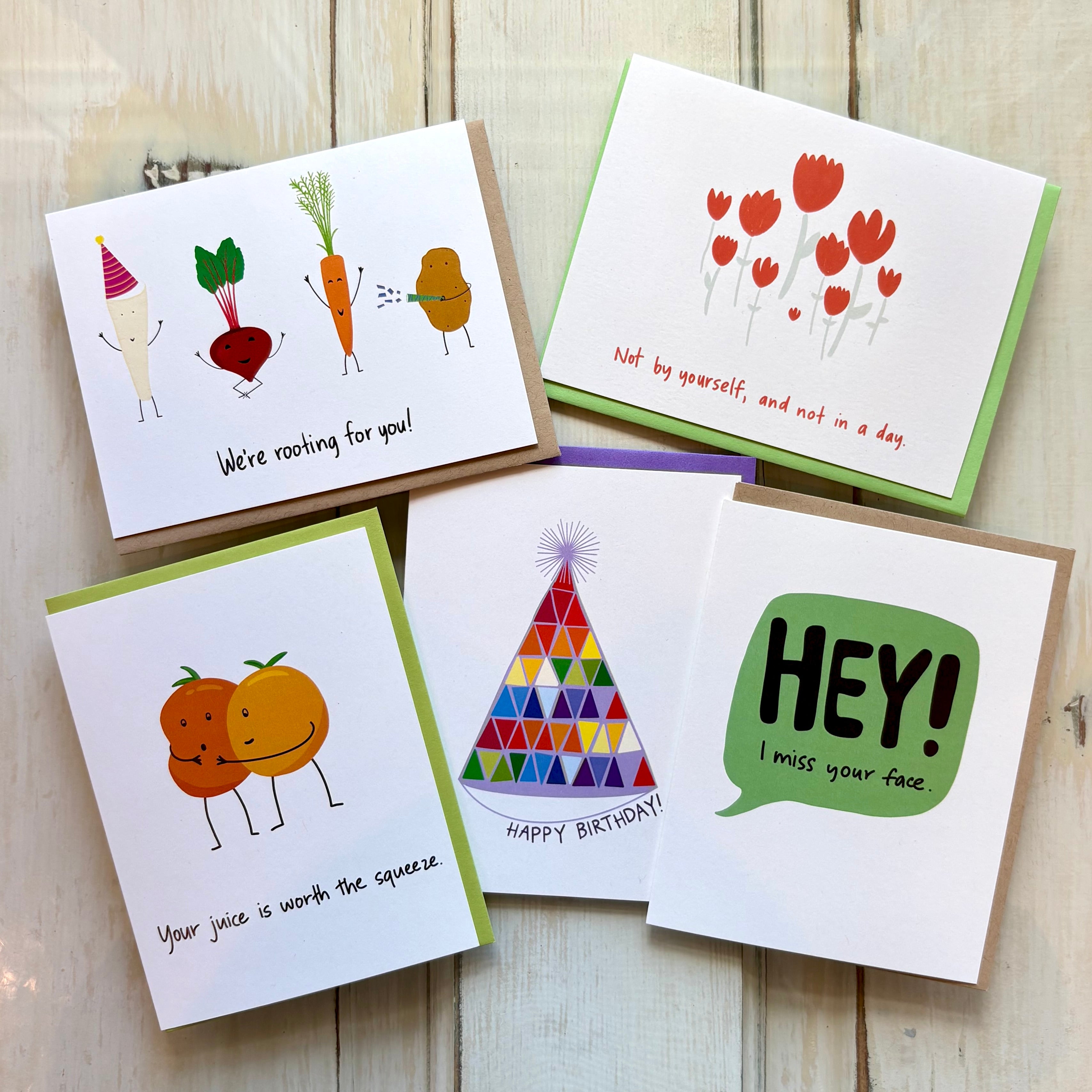 bright fun greeting cards against a wooden background
