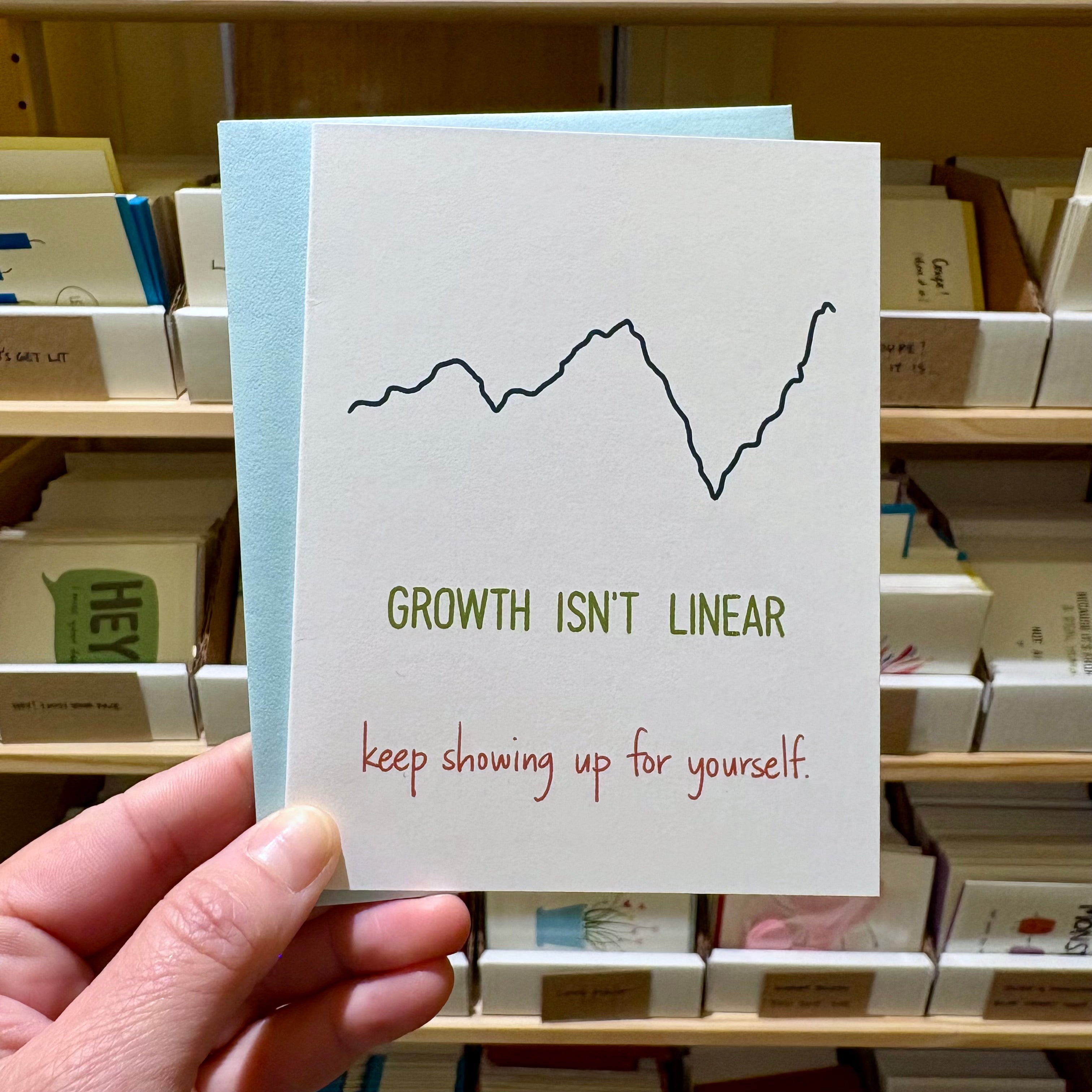 white encouragement card with a varied graph line and text reading "growth isn&