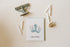 Happy Hanukkah card with a light blue octopus holding candles like a menorah