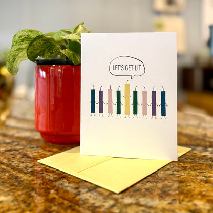 Funny Hanukkah card with candles standing in the shape of menorah and the text, &quot;let&