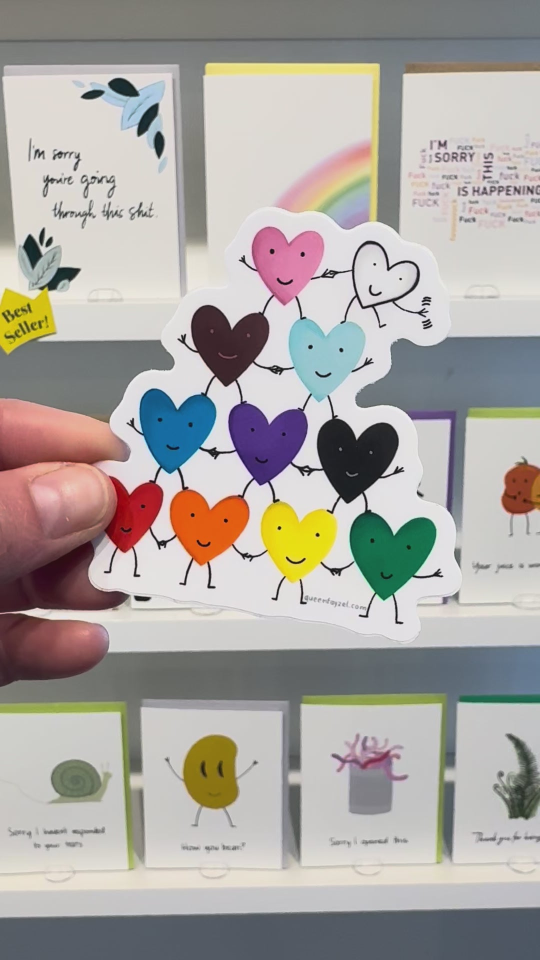 video showing a vinyl pride sticker with a pyramid of rainbow hearts