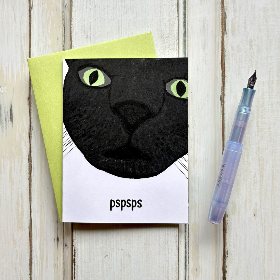 Funny friendship card with a close-up black cat face and "pspsps" text on white background, paired with a bright green envelope
