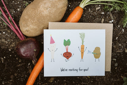 encouragement greeting card with four cheering root vegetables and the text, &quot;We&