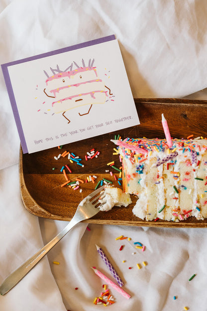 Snarky birthday card with a messy cake and the words, &quot;Hope this is the year you get your shit together&quot;