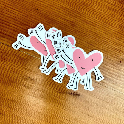 Vinyl sticker with a pink smiling, waving heart