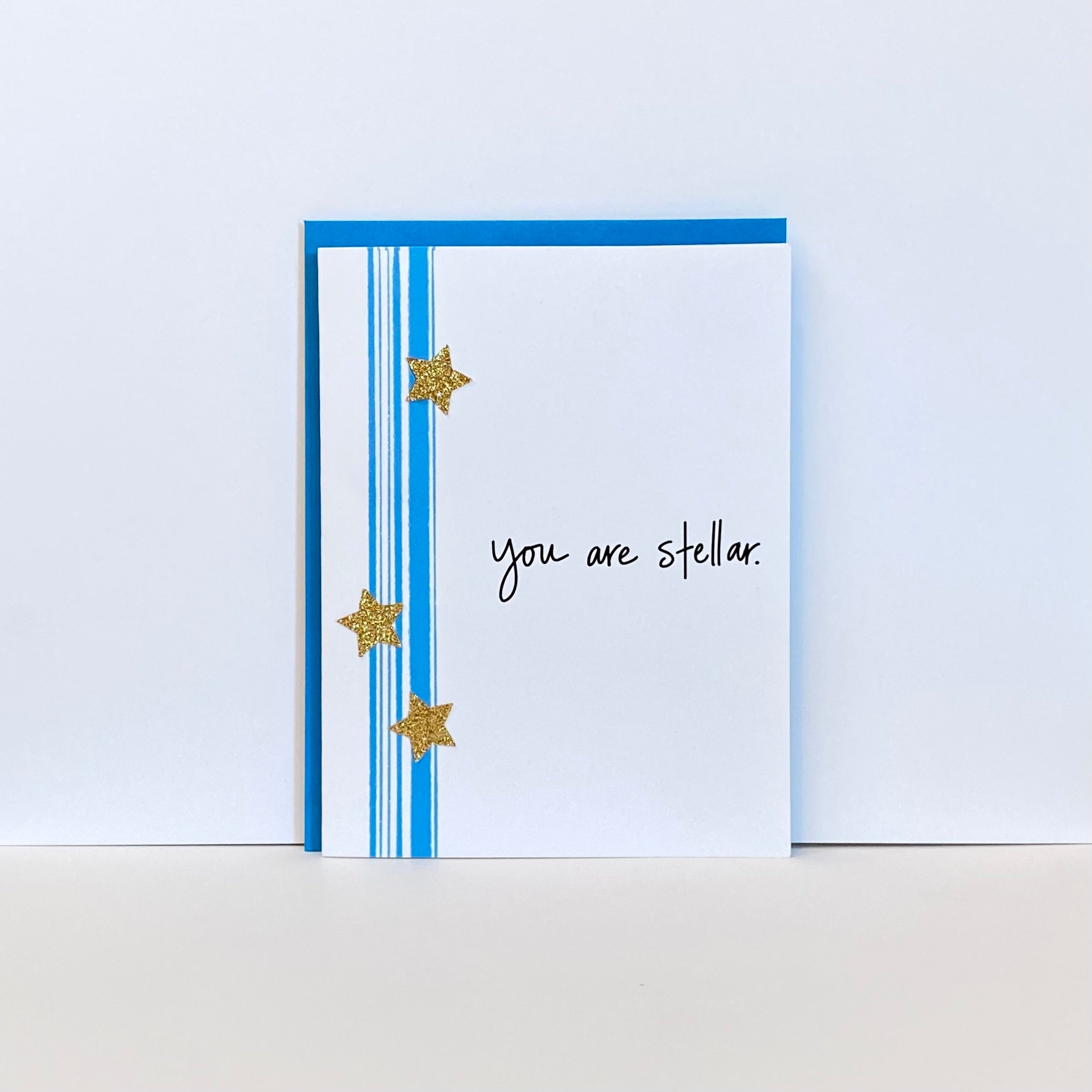 Card with teal stripes, gold stars and the words, &quot;You are stellar&quot;