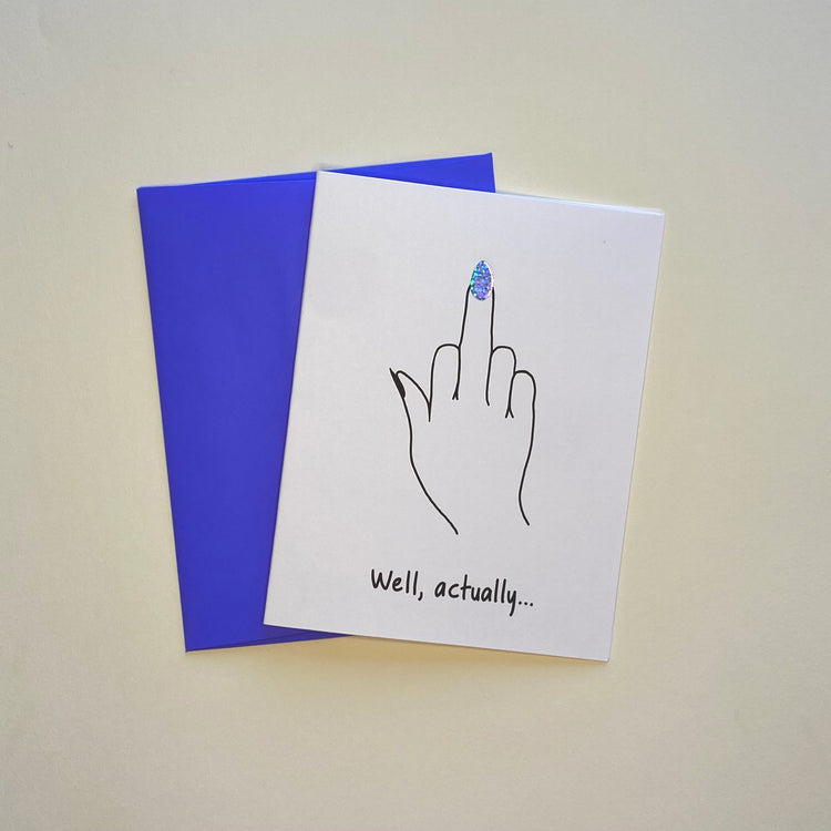 Greeting card showing a hand with a middle finger up and the words, "Well, actually..." The finger has a glittery, pointed fingernail.