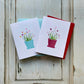 Pair of greeting cards with heart plants, in blue or red.