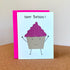 Birthday card with smiling cupcake with pink glitter frosting.