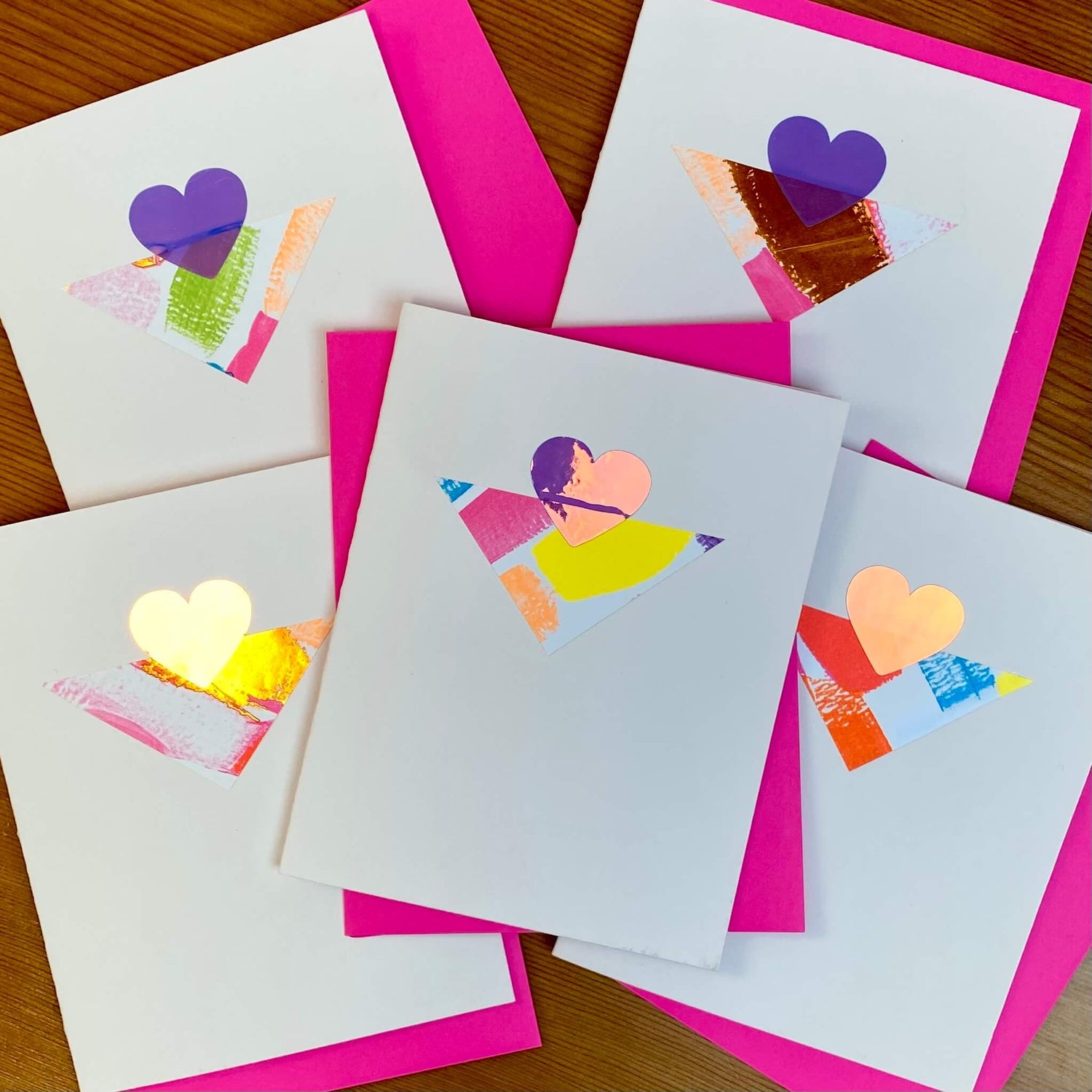 Valentine cards made with blush cardstock, a multi-colored triangle and holographic heart.