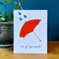 Greeting card with an orange umbrella, three teal glitter raindrops, and the words, "I&