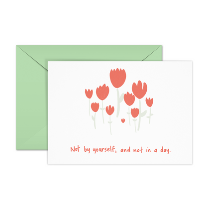 This encouragement affirmation card displays simple red tulip illustrations on a plain white background with the text, "Not by yourself and not in a day."