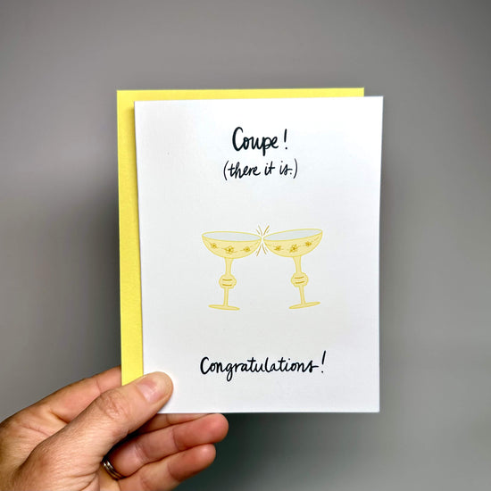 Congratulations card with two clinking coupe glasses and the words, "Coupe! (there it is.)"