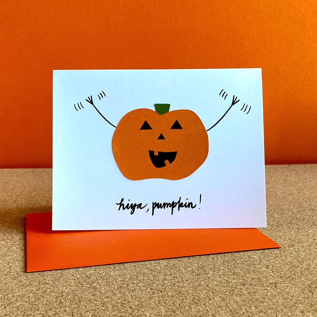 Greeting card with a smiling pumpkin waving its arms and the words, &quot;hiya, pumpkin!&quot;