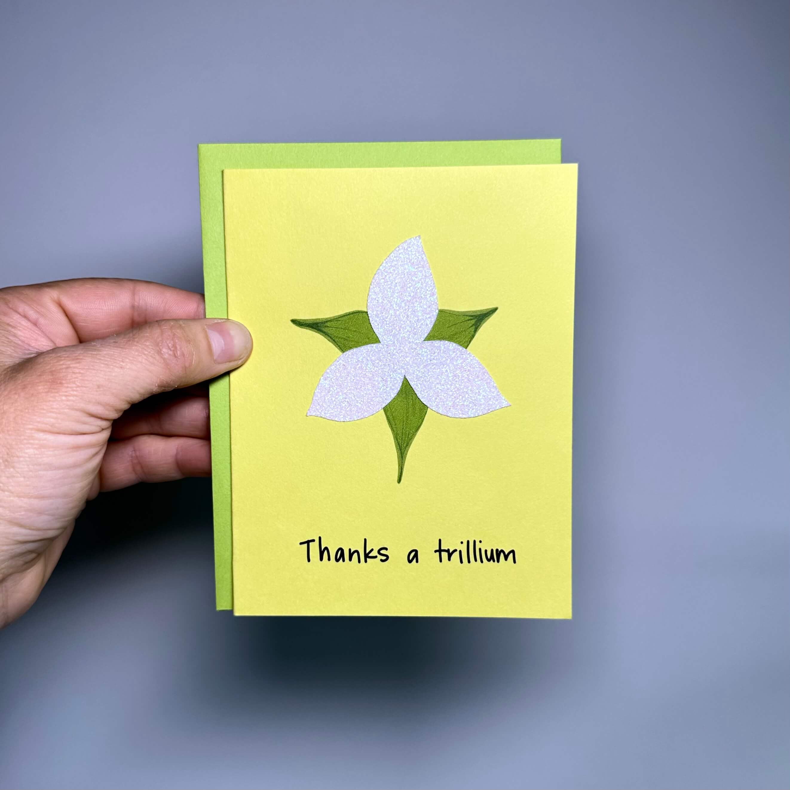 Thank you card on yellow cardstock with a sparkly white trillium and the words, &quot;Thanks a trillium&quot;